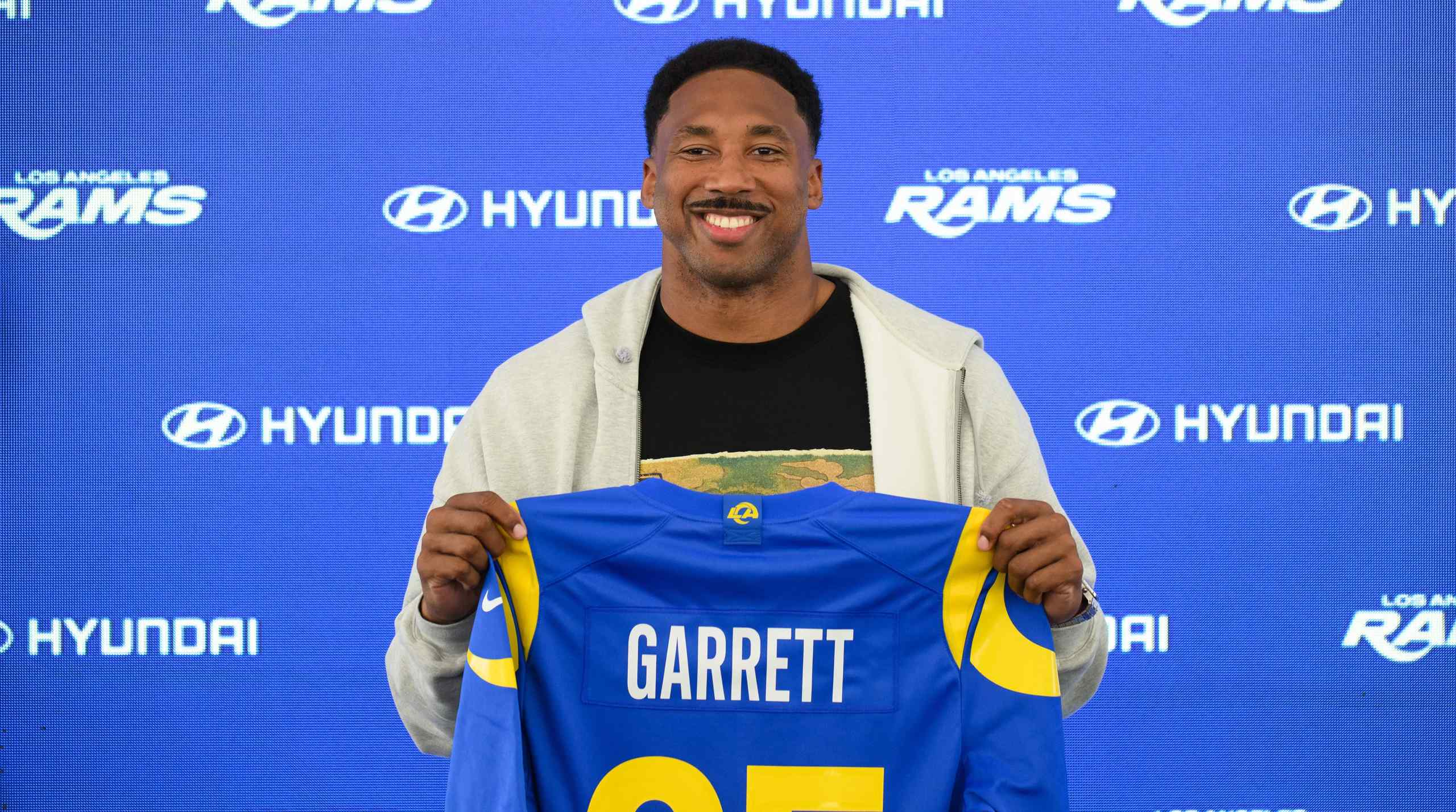 Myles Garrett holding up an LA Rams jersey